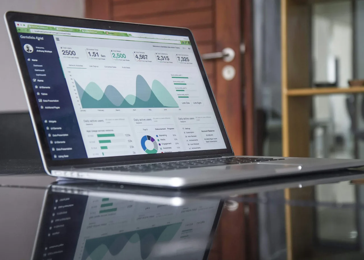 A laptop displaying charts and website statistics.
