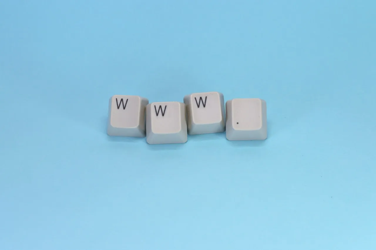 Four white keyboard keys spelling 'www.' on a light blue background.