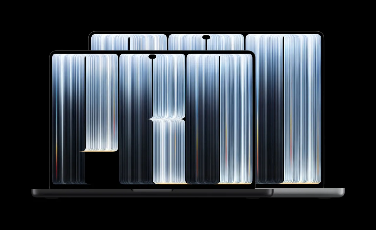 Apple's press image of two open MacBook Pro laptops on a black background: a 14-inch in Space Black in front and a 16-inch in Silver behind it. Their screens show large silvery letters spelling PRO, and a small black cut-out sits at the top centre of each screen.