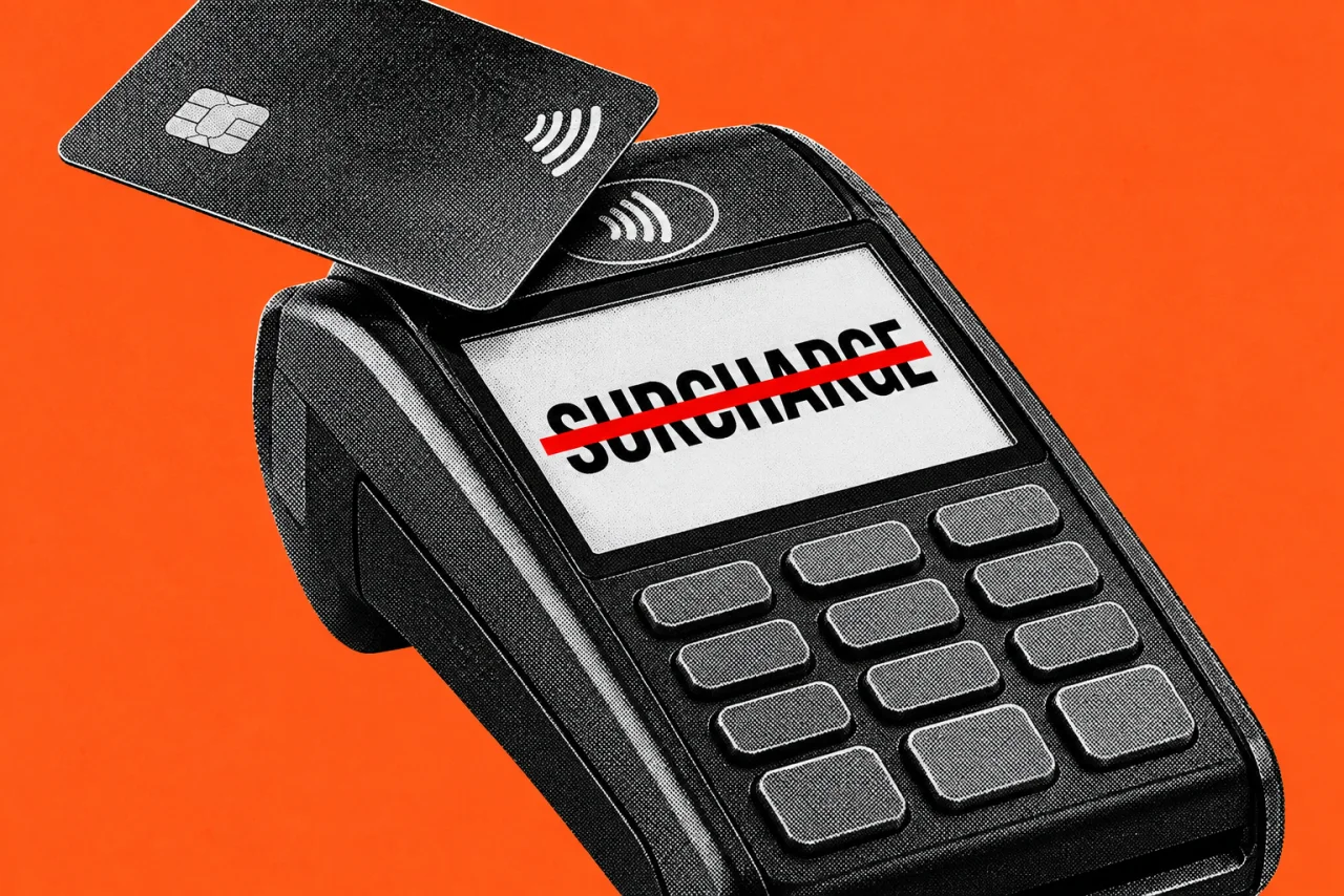A large card payment terminal with a payment card being tapped on it, on an orange background. The terminal's screen shows the word "SURCHARGE" with a thick red line struck straight through it.