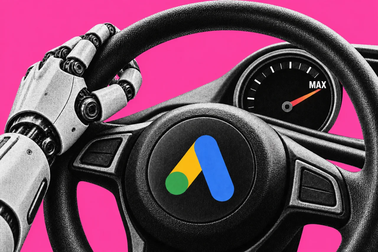 A car steering wheel seen from the driver's seat, with a robot hand gripping it, on a magenta background. The Google Ads logo (the tilted triangle "A" mark in blue, yellow and green) on the centre of the steering wheel, and a small dashboard dial whose needle is pinned at the word "MAX".